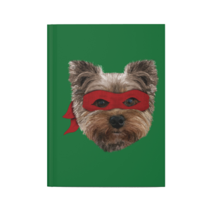 Green hardback journal with a drawing of a Yorkie wearing a red bandana over his eyes